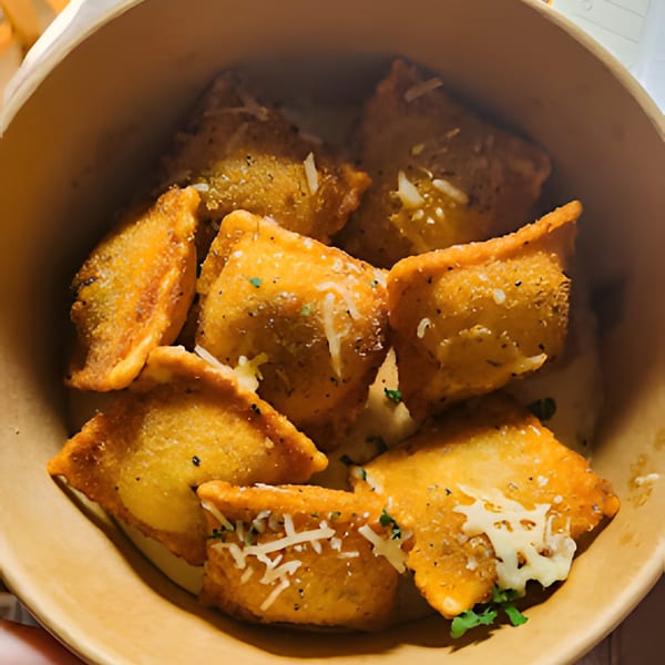 Golden-brown fried ravioli, topped with grated cheese and herbs, served in a brown bowl.